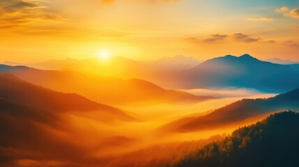 Obraz premium Sunset over a misty mountain range with golden light filtering through the fog, peaceful and serene landscape scene