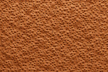 A seamless ostrich embossed leather texture in tan with visible bumps, AI Generated