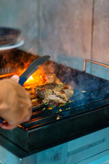 Grilling a Juicy Steak Over Open Flame on a Barbecue Grill