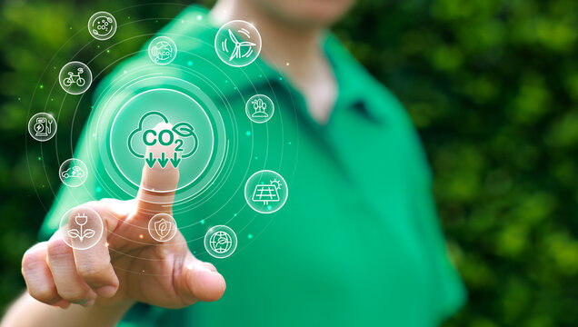 Point by hand with co2, ESG and net zero. Carbon reduction strategy and action to limit climate change and global warming. world environment day, world earth day. green business.