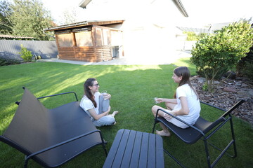 Mother and daughter talking in the backyard