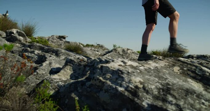 Mountains, walking and hiking man looking at view, scenery or nature on journey, wellness tour or backpacking in Australia. Cliff rocks, blue sky and person trekking for freedom, adventure or trip
