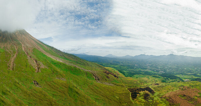 Aerial drone view of green savanna near Mount Sinabung at Berastagi in North Sumatra, Indonesia.
