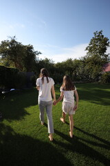 Fototapeta premium Mother and daughter having fun in the backyard