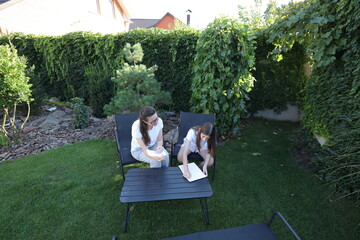 Mother and daughter having fun in the backyard