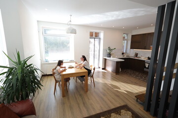 Mother and daughter eating at home