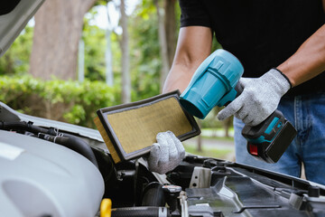 A technician in a workshop uses a wireless device to check a car's condition, updating a digital certificate. The scene highlights automotive repair, service, and efficiency in maintenance.