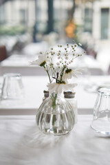 An Elegant Table Setting Featuring a Beautiful Floral Centerpiece in a Cozy Restaurant