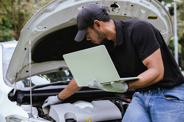 A technician examines a car engine in a garage, focusing on battery and electrical components. The close-up scene emphasizes quality control, maintenance, and automotive expertise.