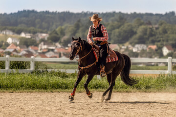 Western riding concept: A young woman and her black quarter horse stallion doing some reining dressage lessons and interacting together