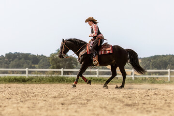 Western riding concept: A young woman and her black quarter horse stallion doing some reining...