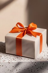  Minimalist, muted-toned gift box with a single, bright orange splash