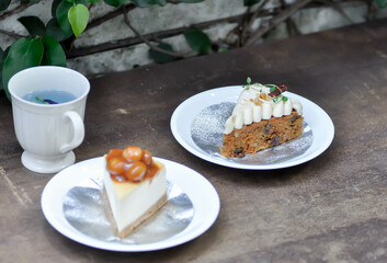 carrot cake with cream and walnut topping ,caramel macadamia cheesecake and butterfly pea tea