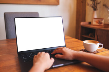 Fototapeta premium Mockup image of a woman using and typing on computer laptop with blank desktop screen at home