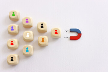 Concept image of a magnet attracting a group of people. metaphor of media influence and human...