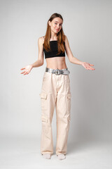 Young Woman in Black Crop Top and Cargo Pants With Hands Out