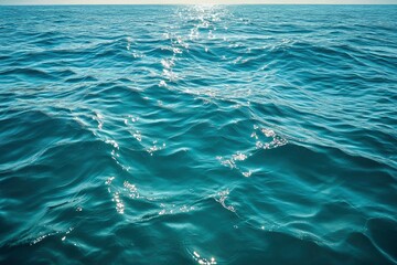 Obraz premium Blue green surface of the ocean in Catalina Island California with gentle ripples on the surface and light refracting , ai