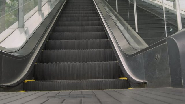 Moving staircase escalator up without people close-up.
