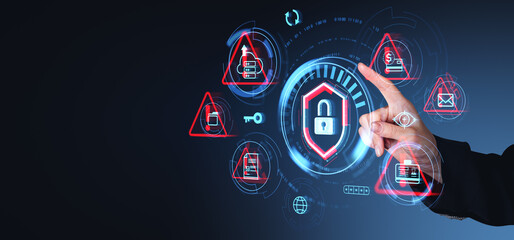 Hand pointing at digital security icons on dark background, illustrating cybersecurity concept.