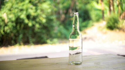 White milk in a glass with blurred background of ornamental plants