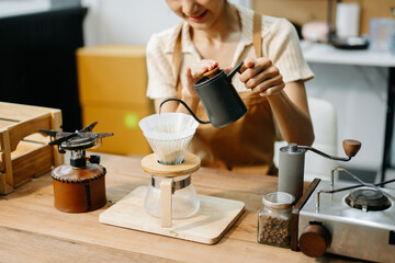 Asian barista brewing fresh espresso. Enjoy a cozy, trendy cafe experience with high quality beans in home or cafe