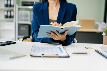 woman hand working with new modern computer and writing on the notepad strategy diagram
