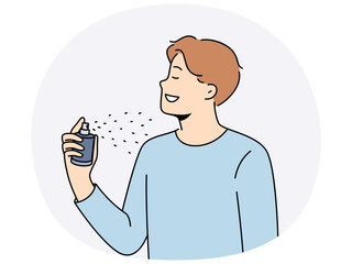 Man holds bottle of perfume and uses it before date with girl to exude good scent. Young guy in casual t-shirt closing eyes, applies perfume or deodorant to body to get rid of bad smell.