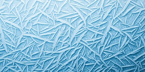 Close-up of intricate frost patterns on a smooth glass surface, creating a beautiful and mesmerizing winter texture in shades of blue.