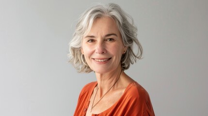 Fototapeta premium Happy middle aged woman with gray hair posing for portrait.