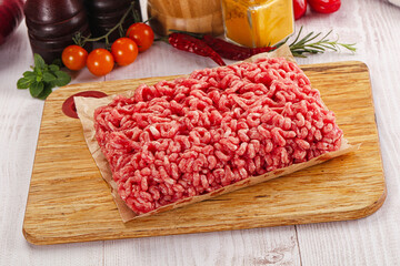 Raw minced beef meat over board