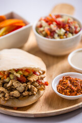 sandwich shawarma chicken in a pita bread salad and pickles middle eastern food israeli food restaurant menu day time