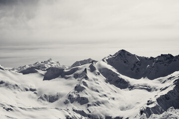 Black and white snowy mountains at winter evening