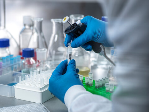 Hand of biologist closing test tube lid during DNA analysis in laboratory