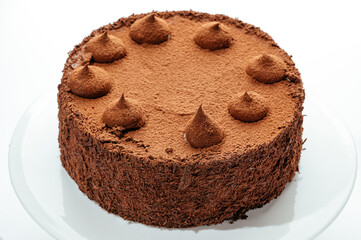 cake with berries, cream and chocolate on a white background