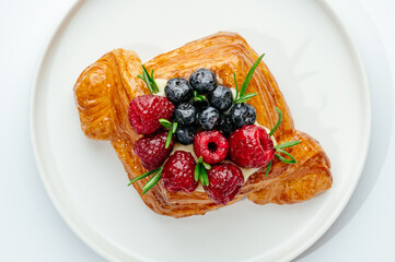 dessert in a clear glass with berries, cream and chocolate
