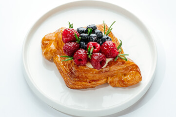 dessert in a clear glass with berries, cream and chocolate