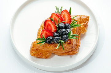 dessert in a clear glass with berries, cream and chocolate