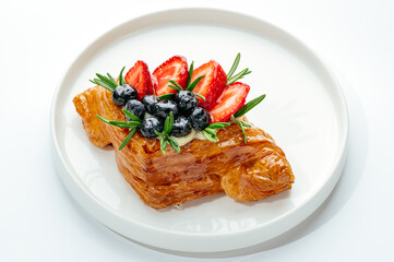 dessert in a clear glass with berries, cream and chocolate