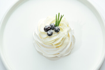 dessert in a clear glass with berries, cream and chocolate