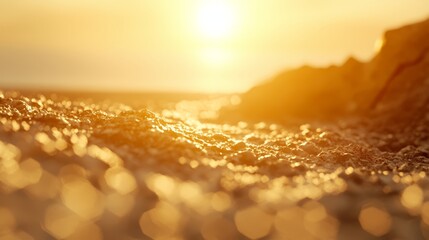   the sun setting over a rocky outcropping on the beach, featuring a distinct foreground rock outcropping