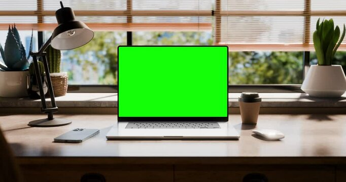 A laptop with a blank screen is placed on a stylish wooden desk with a loft-style interior. The camera moves smoothly to the laptop screen. Screen matte and tracking clip included