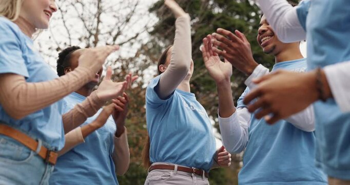 Clapping hands, high five and volunteers in outdoor park with achievement for outreach program. Happy, applause and ngo team cheering for community service partnership in nature for sustainability.