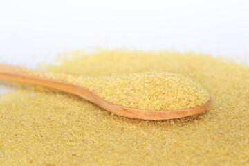 spoon with bulgur which is boiled and cracked wheat