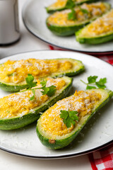 Close-up of Baked Zucchini boats stuffed with ricotta cheese and tuna fish, parmesan cheese. Vertical image.