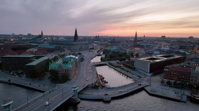 4K Aerial video of downtown Copenhagen in Denmark at sunrise. Christiansborg Palace. Aerial view of a vibrant Cityscape with a stunning bridge