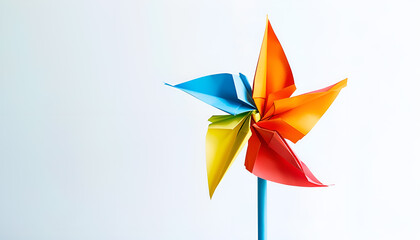 pinwheel or windmill paper origami isolated on white background simple starter craft for kids for weekend entertainment. ESG and Clean Energy Concept. Wind Turbine Paper into the Sky. Decrease Carbon
