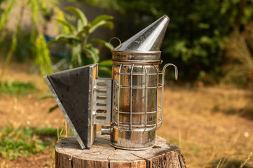 Beekeeping supplies, Bee Hive Smoker on the beehives. The process of extracting honey from the...