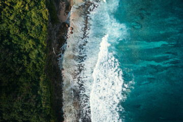 Drone aerial view of coastal cliffs and waves in Penida, Bali, Indonesia