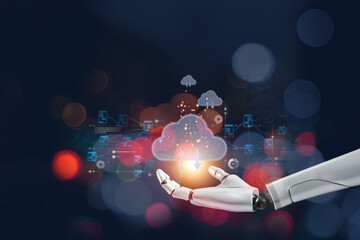 Fototapeta premium A robotic hand holds a glowing cloud symbol, representing the integration of AI and cloud computing technology in data processing.