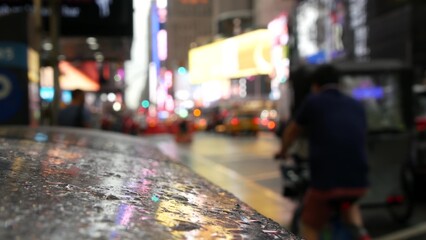 New York City Times Square, Manhattan Midtown Broadway street, USA. Wet american urban road, autumn rainy day, traffic defocused. People pedestrians. Advertising signs, commercial billboard screens.